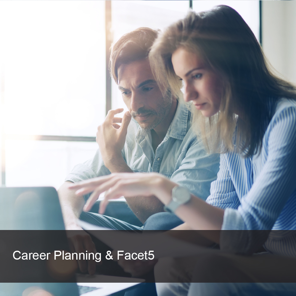 Team leader and team member at computer discussing career plan.